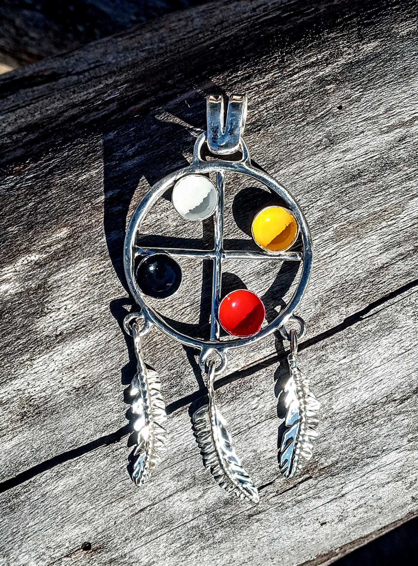 Native American Medicine wheel pendant with handcrafted fine silver feathers