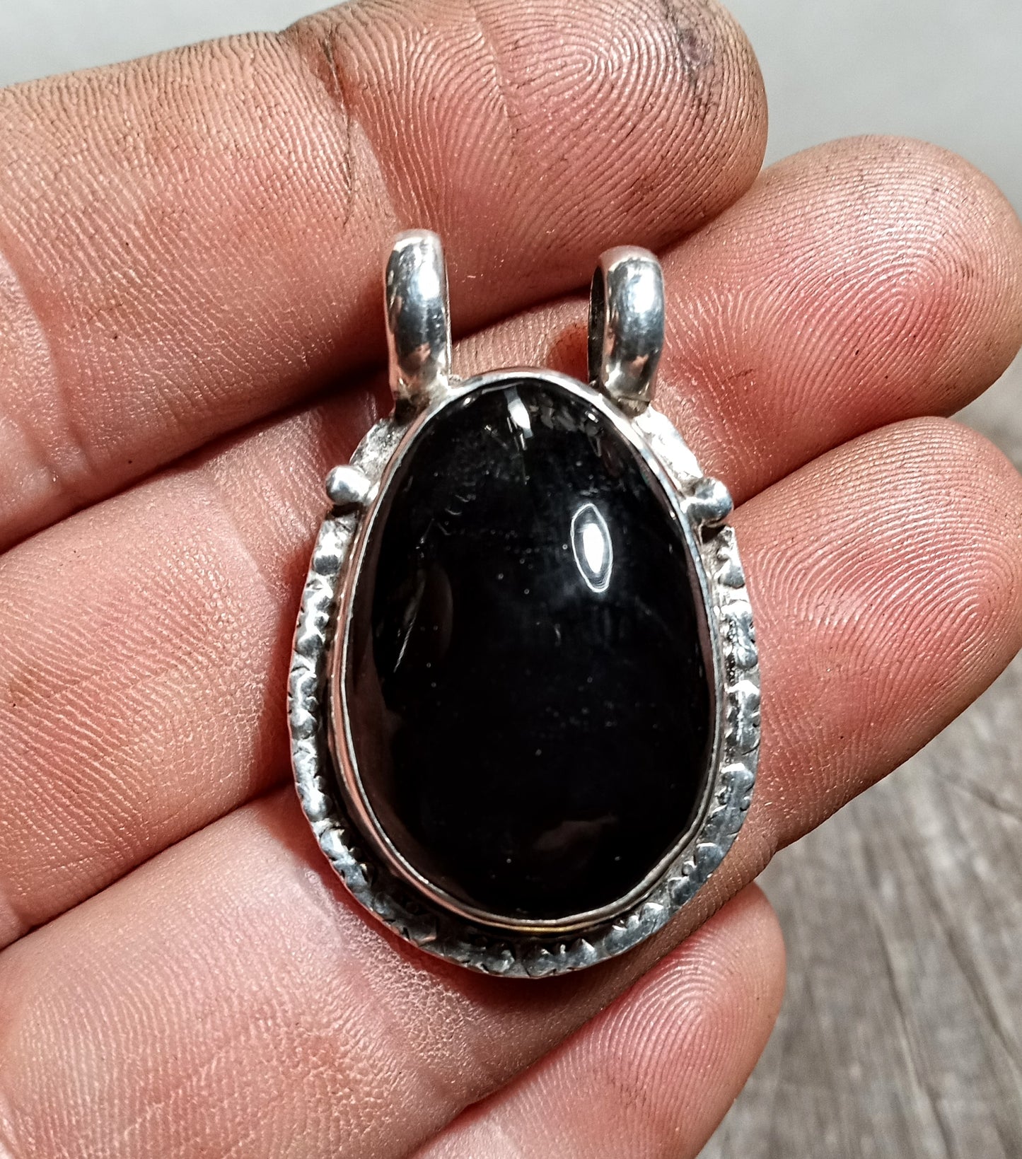 Obsidian pendant set in fine silver with embossed edge
