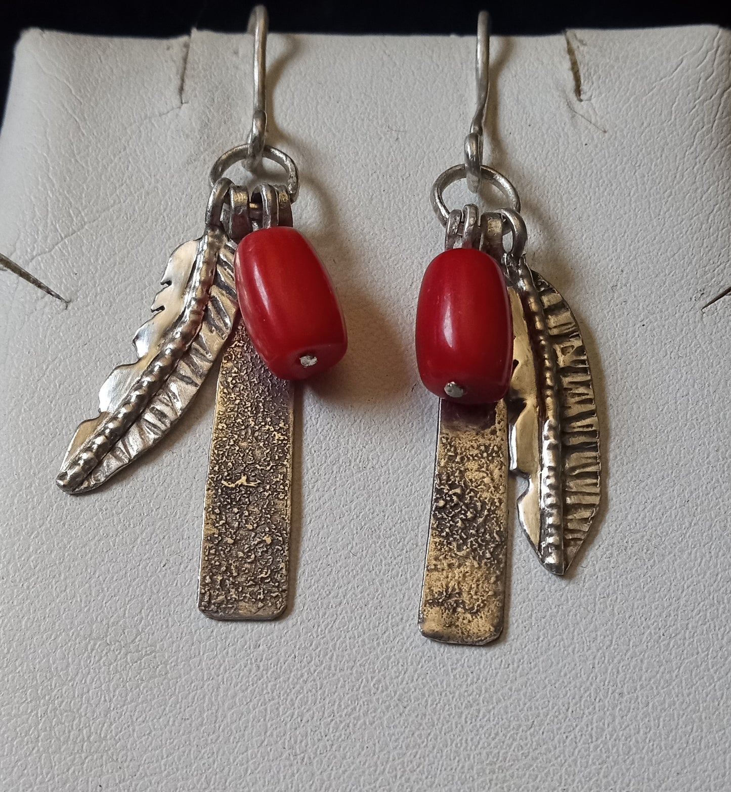 Stunning handcrafted feathers with red coral and decorative blades