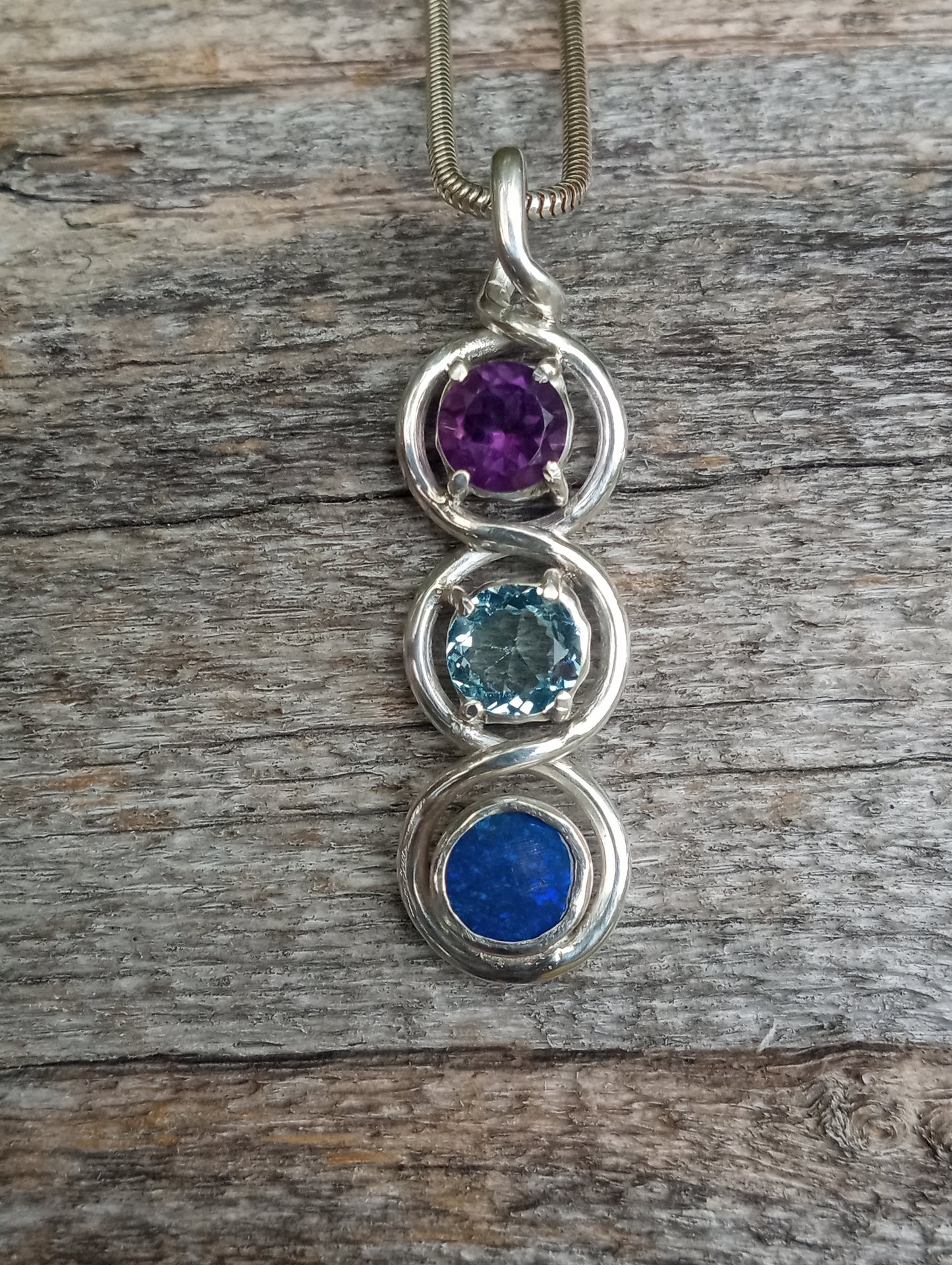 Top class fine silver pendant featuring lightning ridge black opal, aquamarine and amethyst.