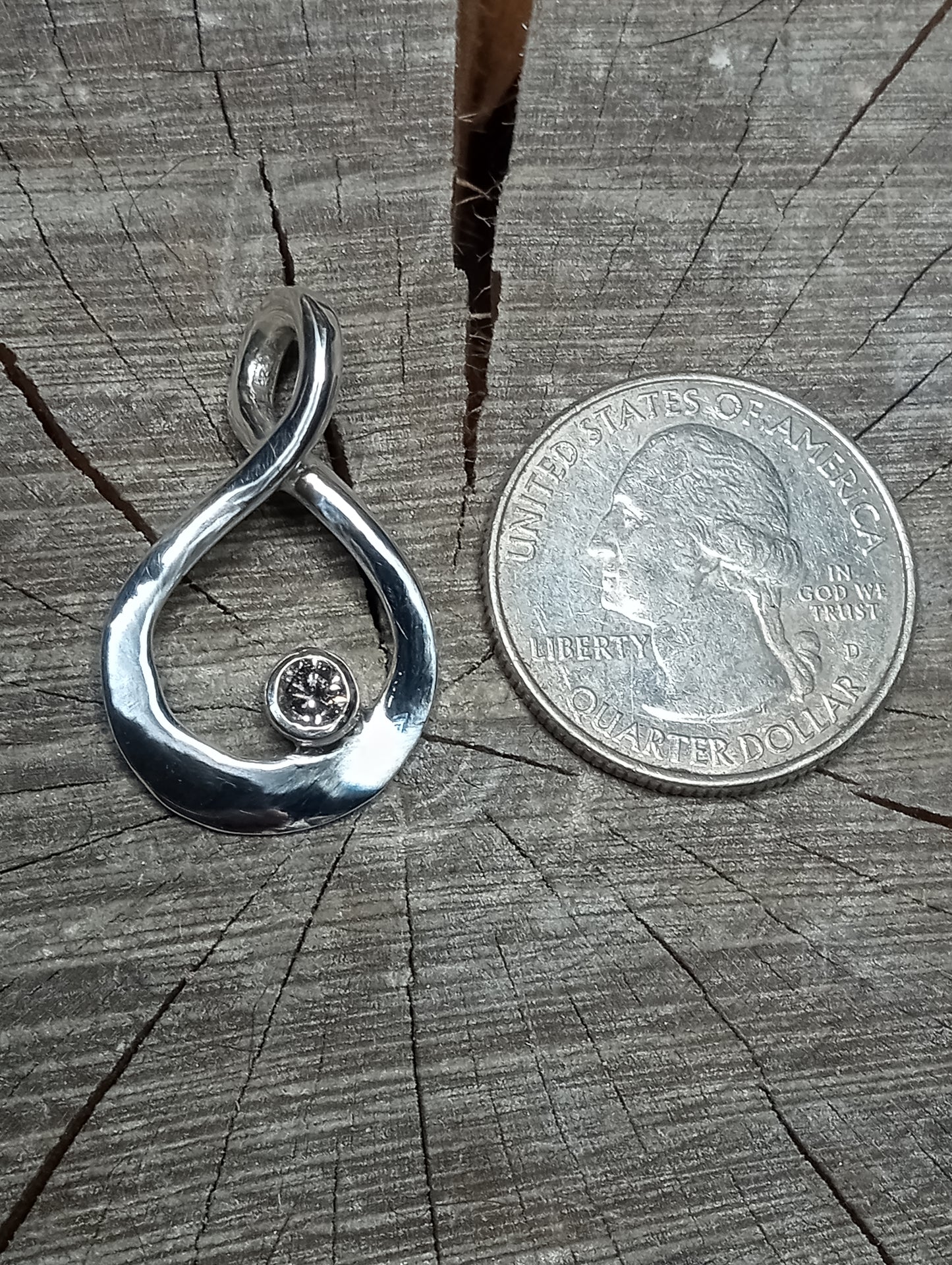 Quarter carat brilliant cut natural silver diamond pendant.