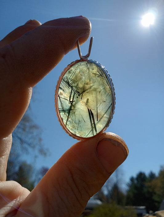 Prehnite pendant with rutilated black tourmaline in fine silver