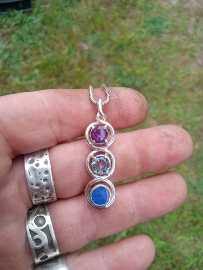 Top class fine silver pendant featuring lightning ridge black opal, aquamarine and amethyst.