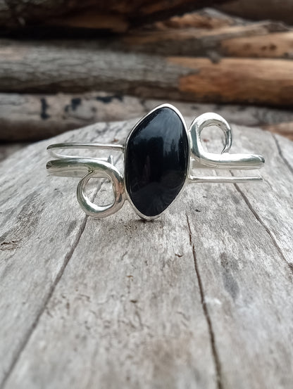 This beautiful cuff I just finished straight off the bench . The setting pure . 999 fine silver the stone obsidian. I hope you enjoy. Be a creator.